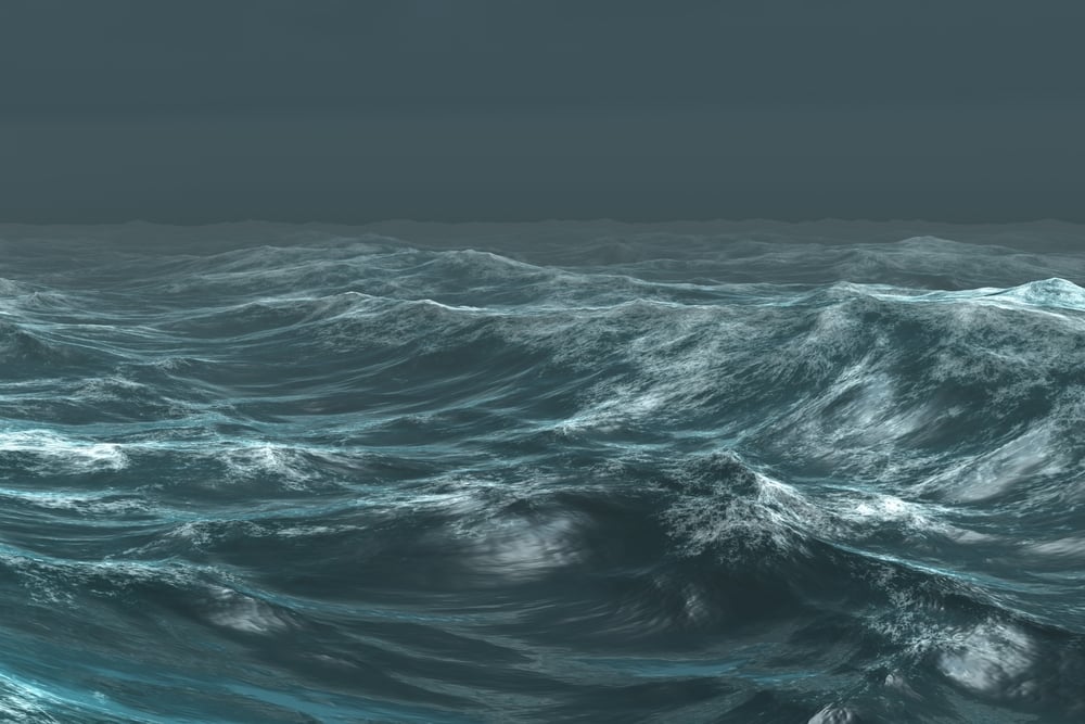 Digitally generated rough blue ocean under dark sky